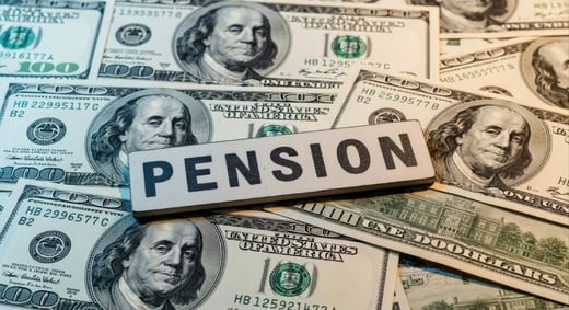 pension sign sitting on 100 dollar bills