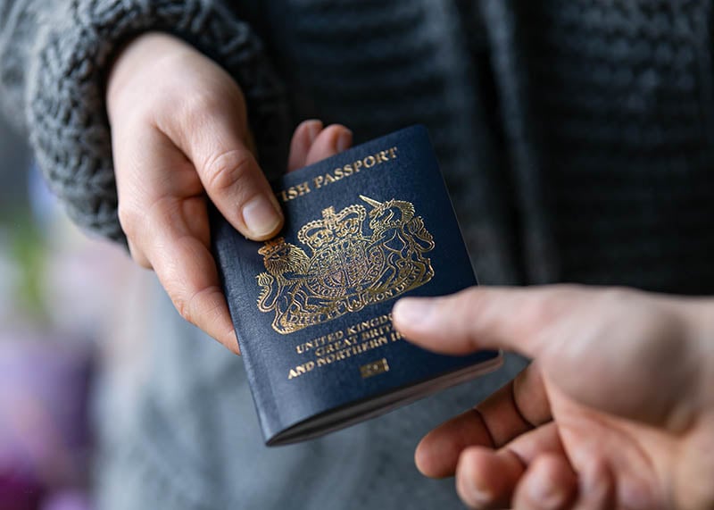 british passport being handed over 800