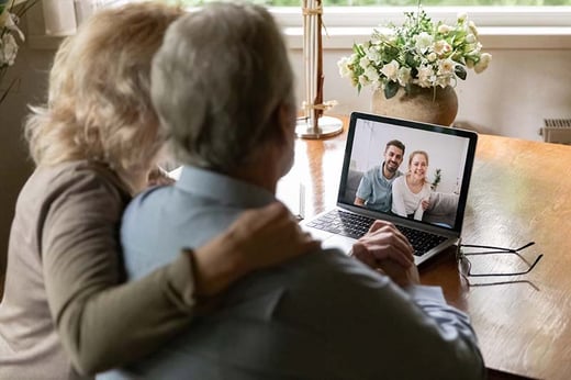elderly couple on video call with younger relatives
