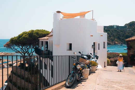 white house on the med in spain with woman walking towards