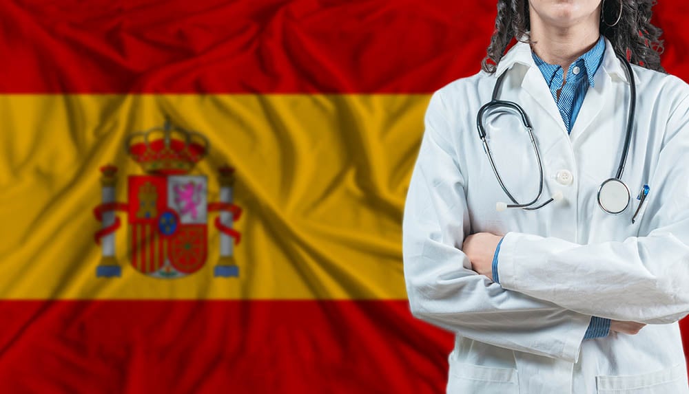 medical professional in front of spanish flag