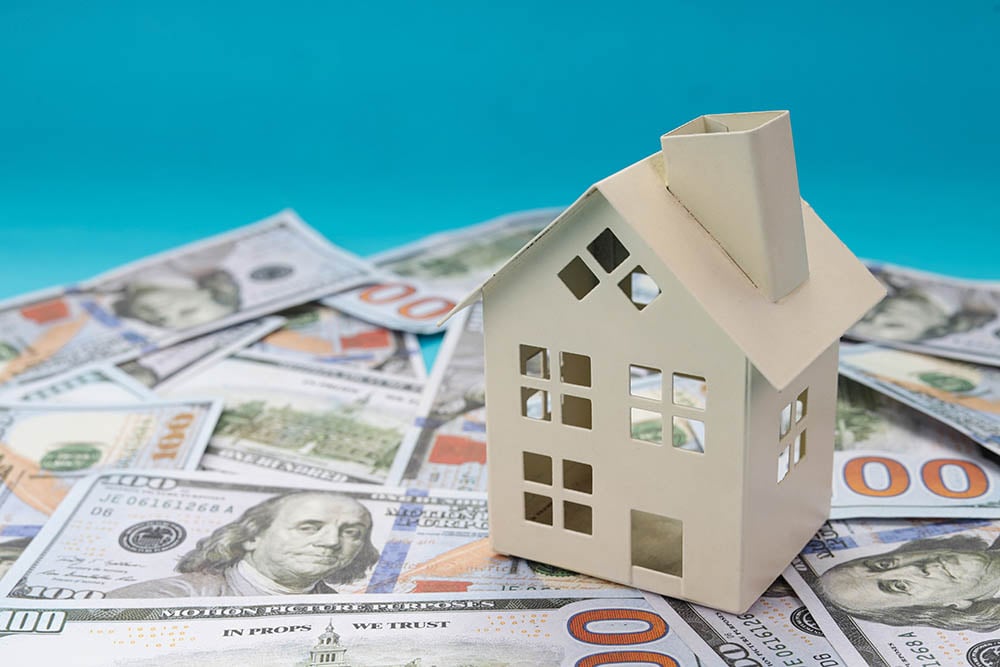 model house on dollar bills