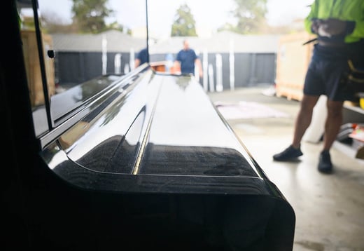 close up of a piano being moved
