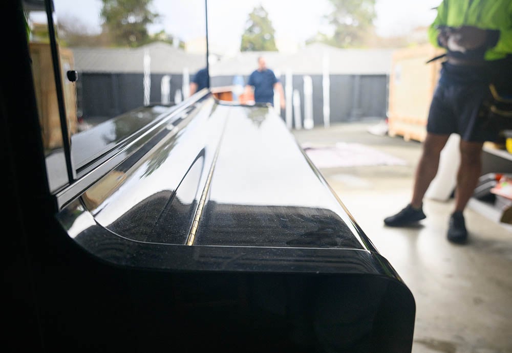 close up of a piano being moved