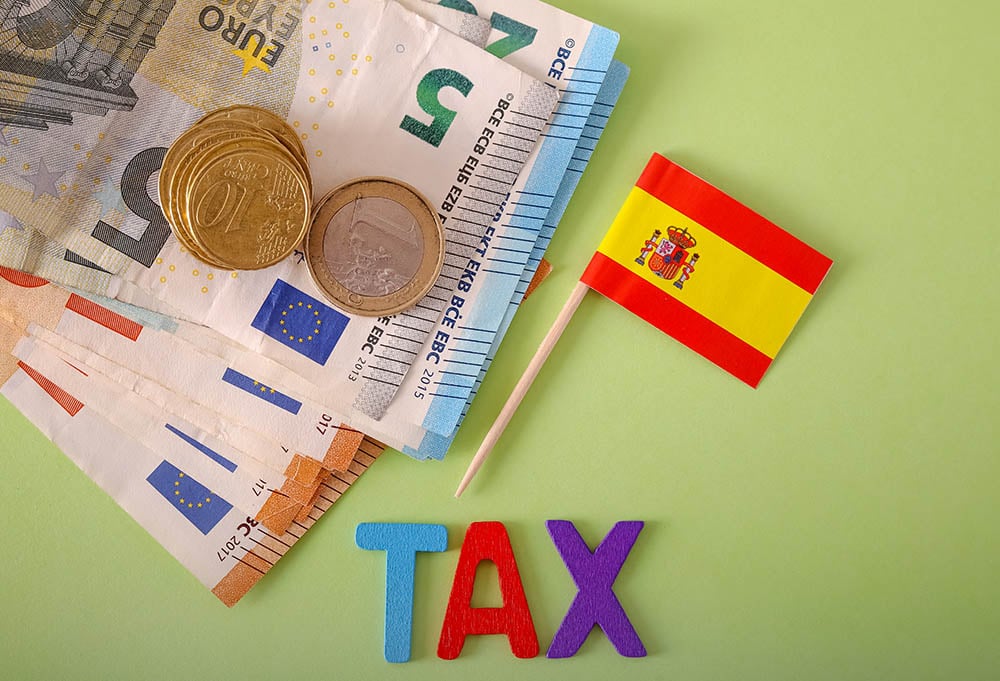 spain flag with euros and tax sign