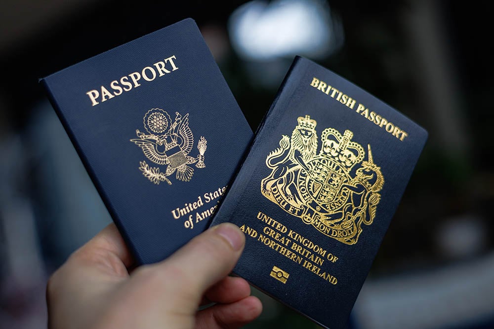 person holding us and uk passports