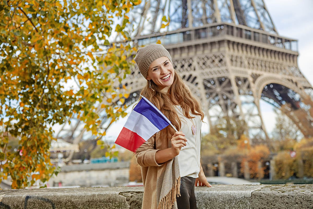 woman holding french flag in paris