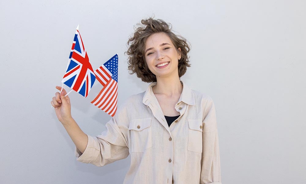 woman holding uk and us flags