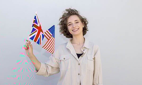 woman holding uk and us flags