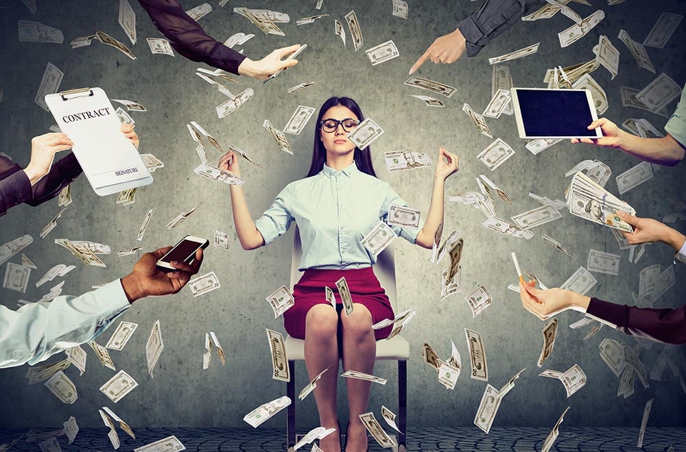 woman sitting in chaos with money